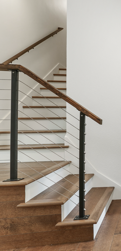 Floating wood staircase with cable railing